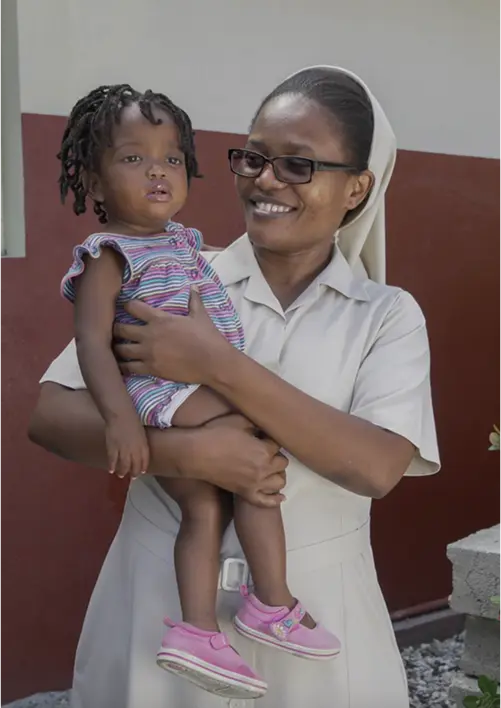 Nurse with a child on her lap