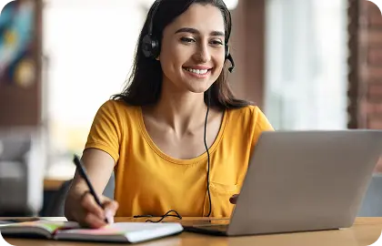 Student taking an online exam using a laptop in a focused environment