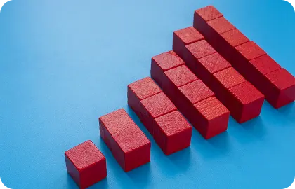 Stacked red blocks on a blue background, symbolizing a scalable and self-managed learning system